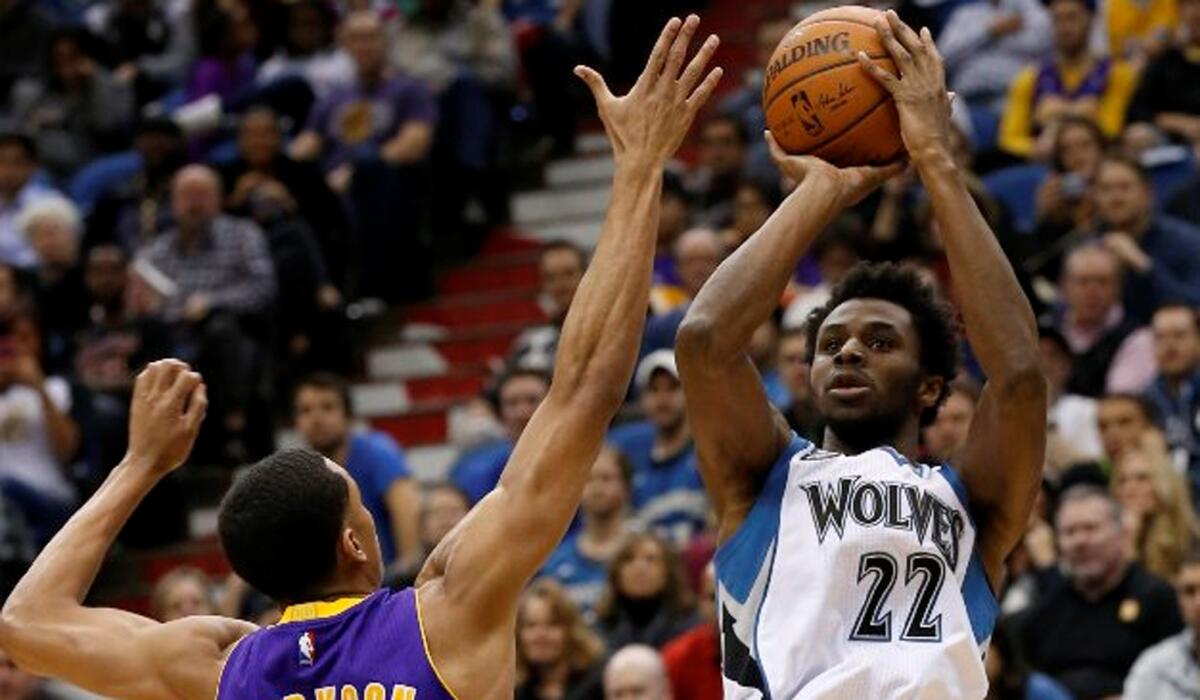 Timberwolves guard Andrew Wiggins (22) goes up for a shot against Lakers guard Jordan Clarkson (6) during the first half.