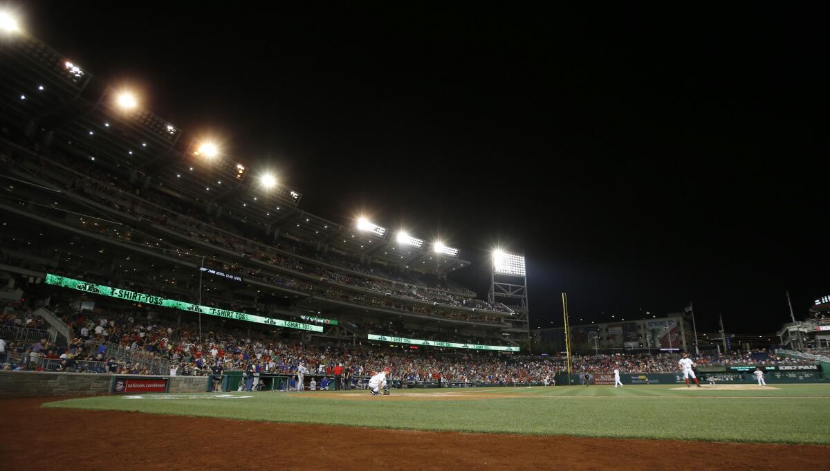 Some of the lights go out during the sixth inning of a baseball game between the Washington Nationals and the Los Angeles Dodgers at Nationals Park, Friday, July 17, 2015, in Washington. The game was halted twice after the some of the lights went out, and suspended when it happened for a third time. They will continue the game Saturday. (AP Photo/Alex Brandon)