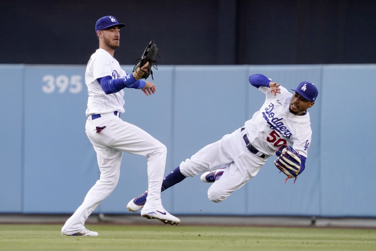 Dodgers right fielder Mookie Betts falls after colliding with center fielder Cody Bellinger.