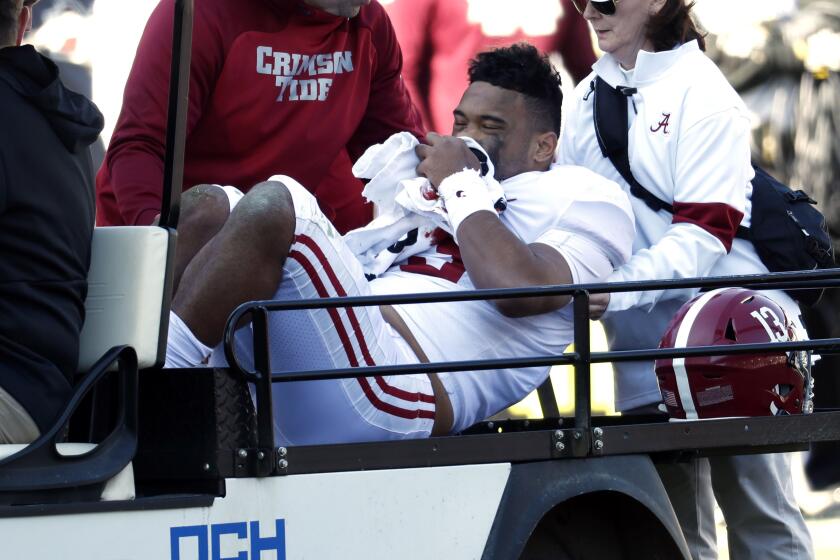 Alabama quarterback Tua Tagovailoa is carted off the field after suffering an injury during the first half of a game against Mississippi State on Nov. 16. 