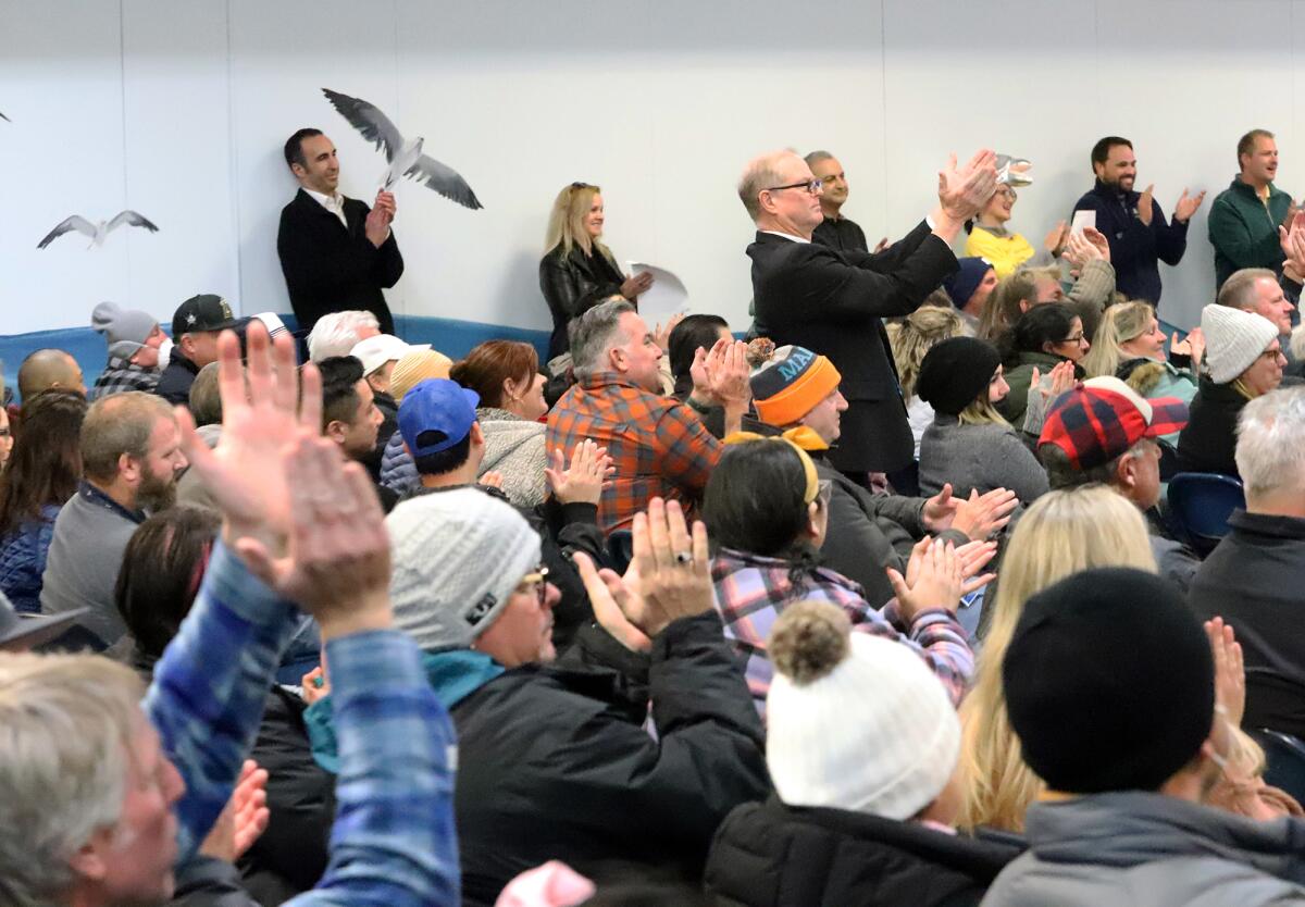 Parents applaud after Village View fifth-grader Abby Jimenez spoke about the importance of keeping schools open on Wednesday.