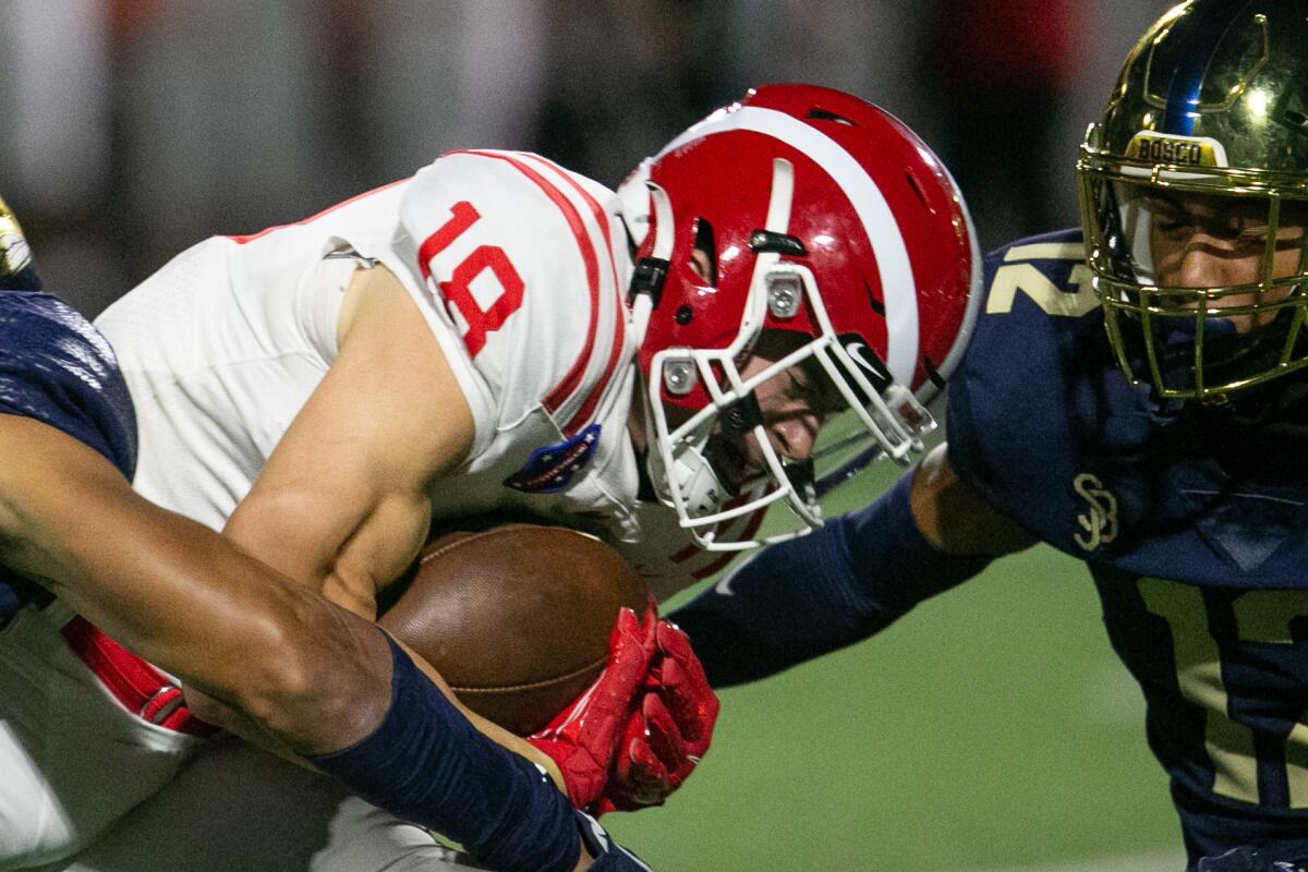 Mater Dei wide receiver Cooper Barkarte looks for yards after a catch against St. John Bosco.