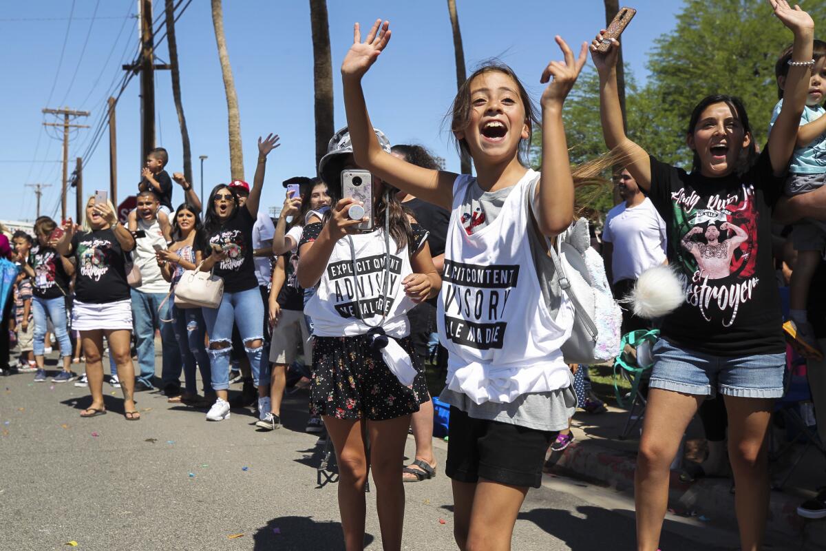 People cheer at a June parade for boxing champion Andy Ruiz Jr. in Imperial, Calif.
