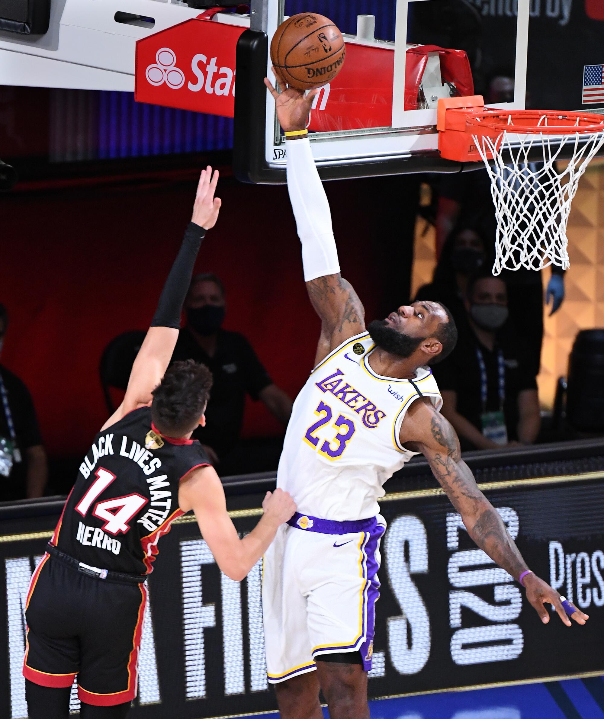 Lakers forward LeBron James blocks a shot by Heat guard Tyler Herro during Game 3.