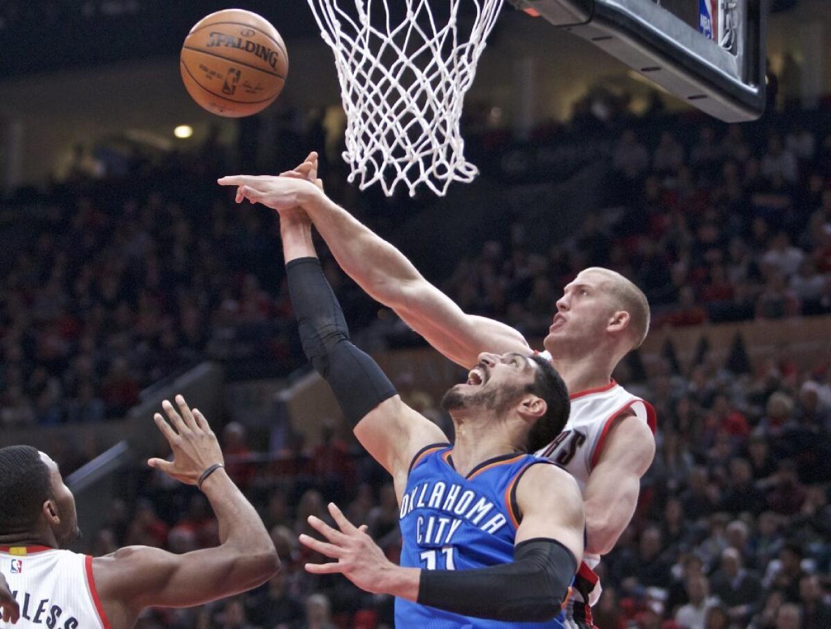 Trail Blazers center Mason Plumlee blocks the shot of Thunder center Enes Kanter during the first half of a game on Dec. 13.
