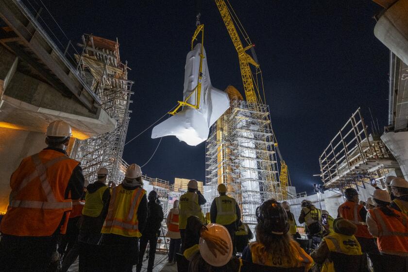 Los Angeles, CA - January 30: The retired space shuttle Endeavour is lifted into the site of the future Samuel Oschin Air and Space Center at California Science Center on Tuesday, Jan. 30, 2024 in Los Angeles, CA. (Ringo Chiu / For The Times)