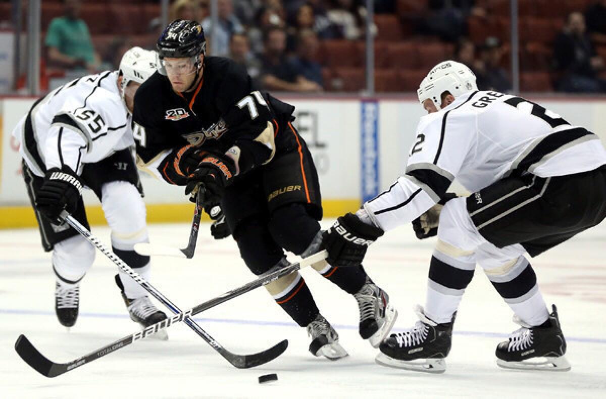 Center Peter Holland, center, shown skating against the Kings' Jeff Schultz, left, and Matt Greene in a preseason game, couldn't break through with the Ducks, who are well stocked at center.