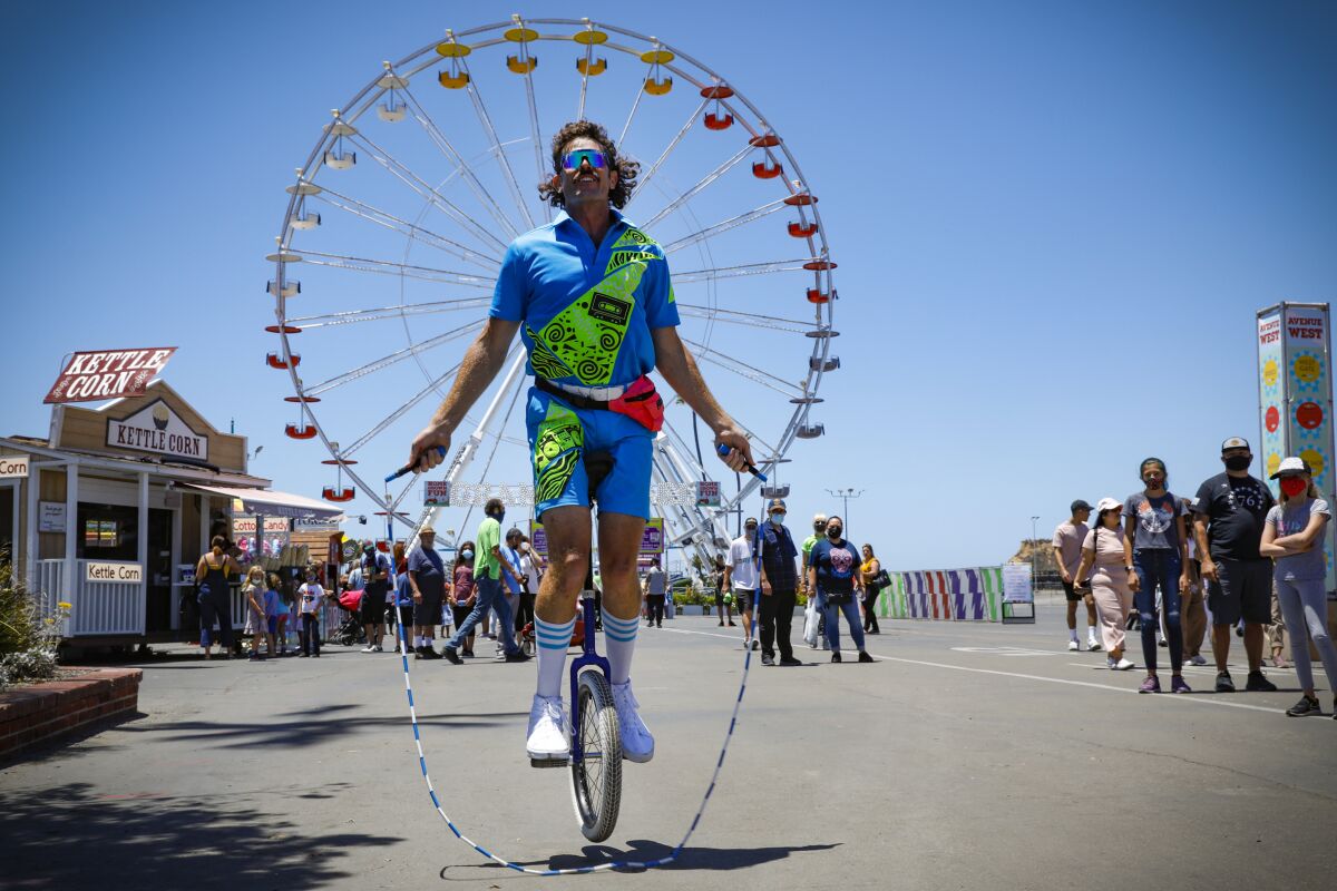 Unicyclist Mark Wilder entertains fairgoers by jumping rope on his unicycle at the San Diego County Fair.