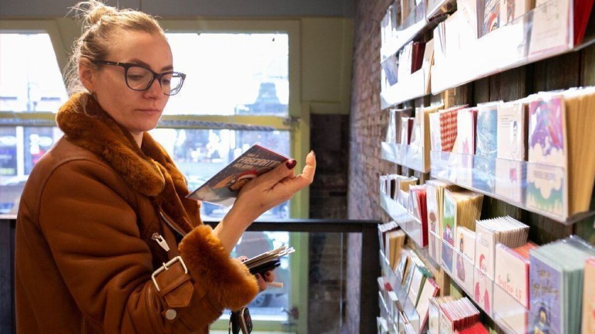 Erin Delaney shops for holiday cards at a Paper Source store in Chicago.