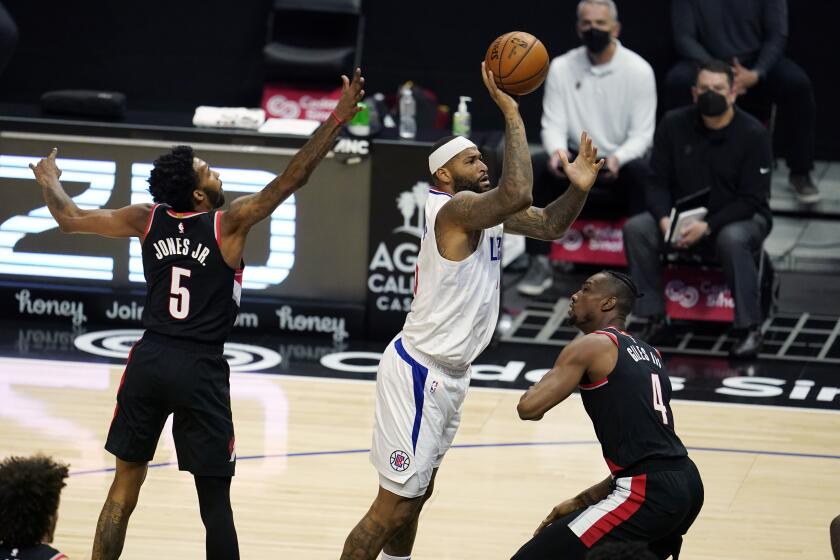 Los Angeles Clippers center DeMarcus Cousins, center, shoots against the Portland Trail Blazers during the second half of an NBA basketball game Tuesday, April 6, 2021, in Los Angeles. (AP Photo/Marcio Jose Sanchez)
