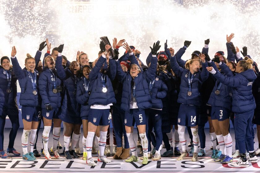 The U.S. team hoists the SheBelieves Cup trophy after a 5-0 win over Iceland in a soccer match Wednesday, Feb. 23, 2022 in Frisco, Texas. (AP Photo/Jeffrey McWhorter)