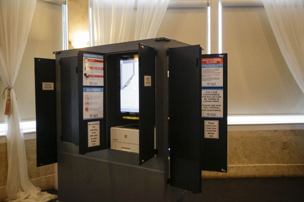 FILE - New state-issued voting machines used for the Georgia primary election on June 9, 2020, are seen at Park Tavern in Atlanta. The U.S. Cybersecurity and Infrastructure Security Agency released a final version Friday, June 3, 2022, of an advisory it previously sent state officials on voting machine vulnerabilities in Georgia and other states that voting integrity activists say weakens a security recommendation on using barcodes to tally votes. (AP Photo/Brynn Anderson, File)