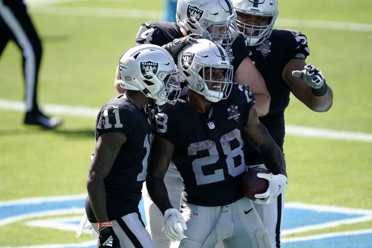 Las Vegas Raiders running back Josh Jacobs (28) celebrates after scoring during the second half of an NFL football game against the Carolina Panthers Sunday, Sept. 13, 2020, in Charlotte, N.C. (AP Photo/Brian Blanco)