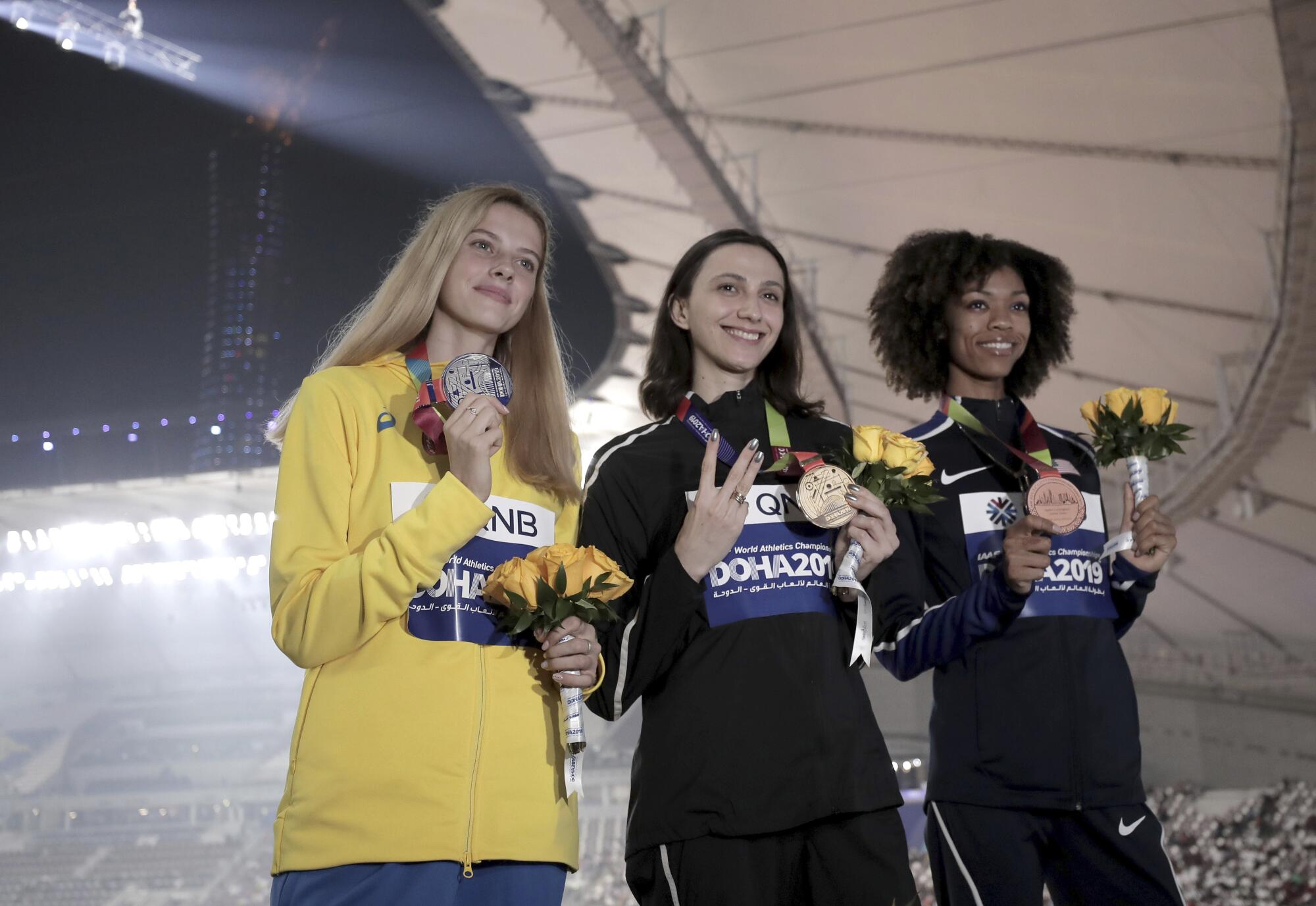 American Vashti Cunningham, right, joins gold medalist Mariya Lasitskene, center, and silver medalist Yaroslava Mahuchikh.