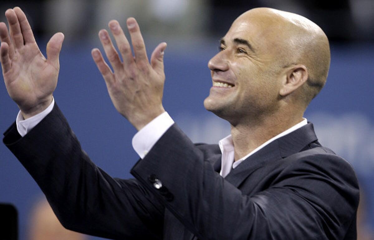 Andre Agassi greets the crowd while being honored during the "Evening with Legends" at the opening night festivities of the U.S. Open tennis tournament in 2009.