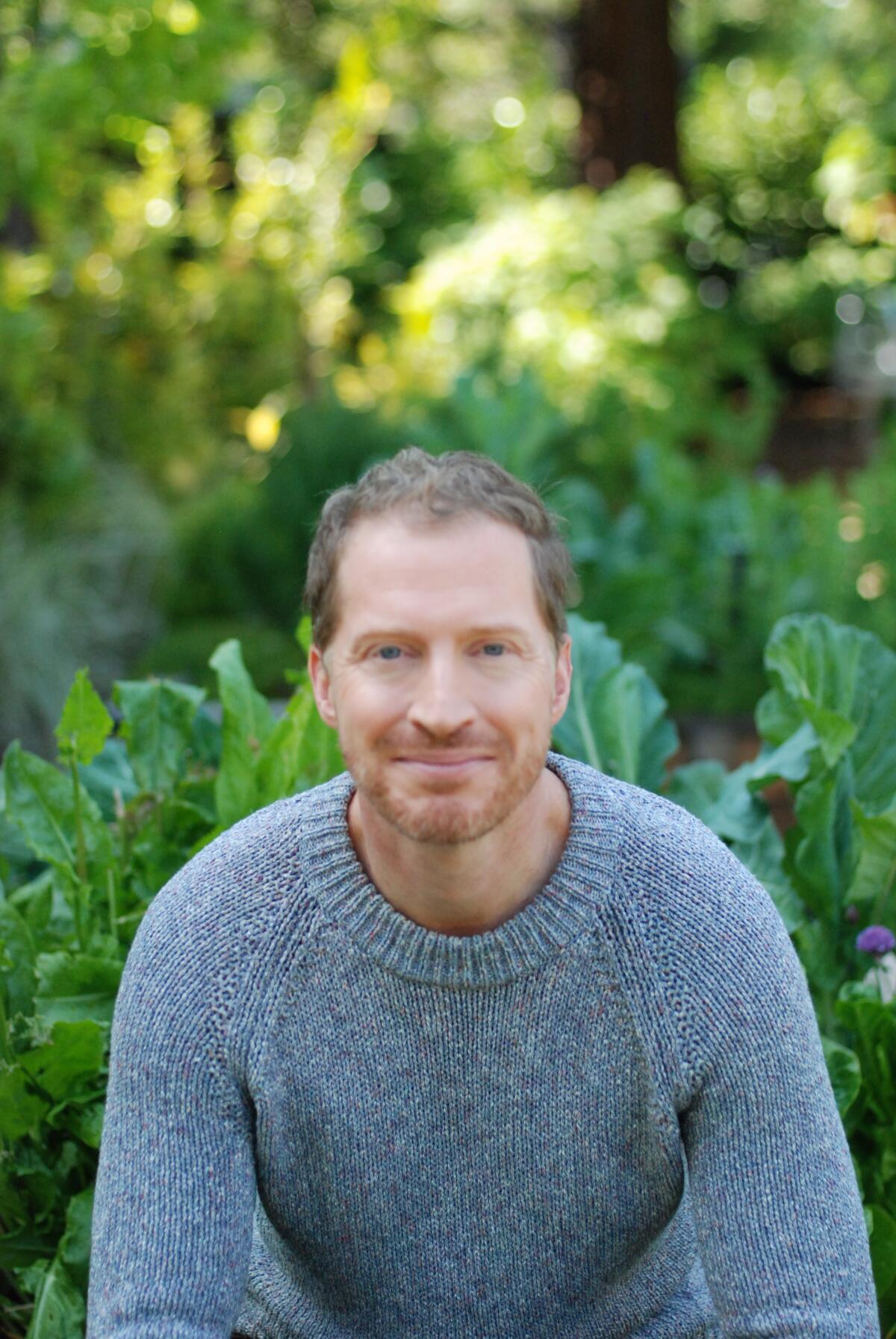 Headshot of a man in a sweater