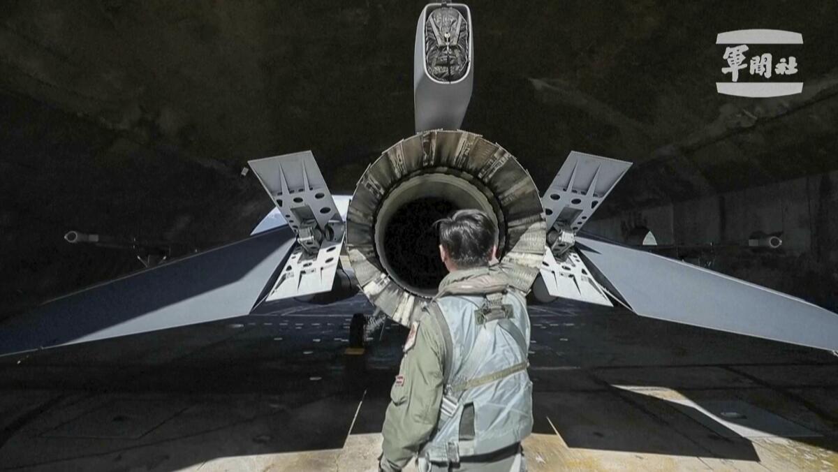 A Taiwanese pilot checks on a fighter jet 