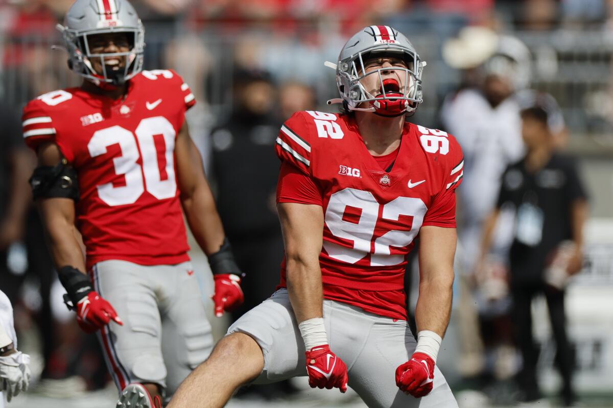 Ohio State defensive lineman Caden Curry, right, celebrates a sack against Arkansas State during the second half of an NCAA college football game Saturday, Sept. 10, 2022, in Columbus, Ohio. (AP Photo/Jay LaPrete)