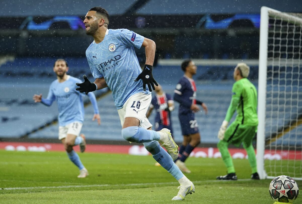 Manchester City's Riyad Mahrez celebrates after scoring his sides second goal during the Champions League semifinal second leg soccer match between Manchester City and Paris Saint Germain at the Etihad stadium, in Manchester, Tuesday, May 4, 2021. (AP Photo/Dave Thompson)