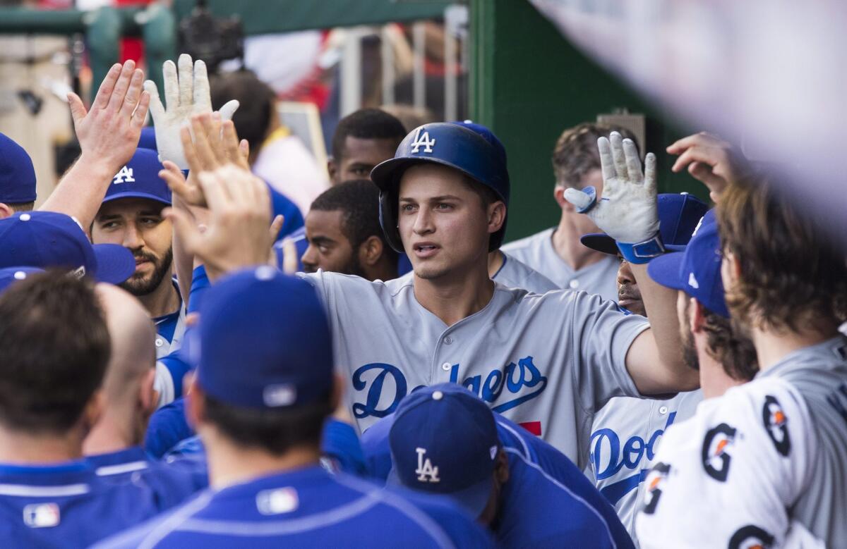 Corey Seager gets high-fives all around after homering in the first inning.
