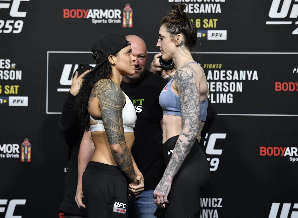 Amanda Nunes and Megan Anderson of Australia face off during the UFC 259 weigh-in in Las Vegas on Saturday.