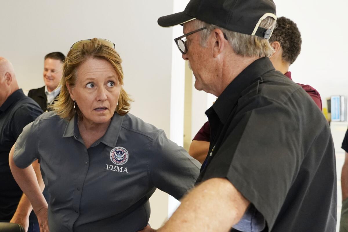 Deanne Criswell, administrator of the Federal Emergency Management Agency (FEMA), left, confers with Jim Craig of the Mississippi State Health Department, during a visit to the City of Jackson's O.B. Curtis Water Treatment Facility in Ridgeland, Miss., Friday, Sept. 2, 2022. Jackson's water system partially failed following flooding and heavy rainfall that exacerbated longstanding problems in one of two water-treatment plants. (AP Photo/Rogelio V. Solis, POOL)