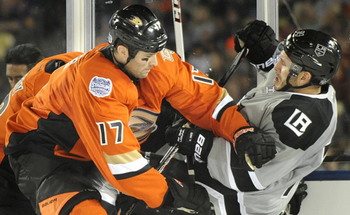 Ducks forward Dustin Penner, left, checks Kings forward Dwight King during the Ducks' 3-0 victory at Dodger Stadium on Saturday night.