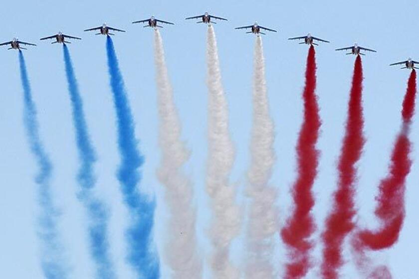 The Patrouille de France demonstration team of the French air force flies above the Champs Elysee during the Bastille Day military parade in Paris.