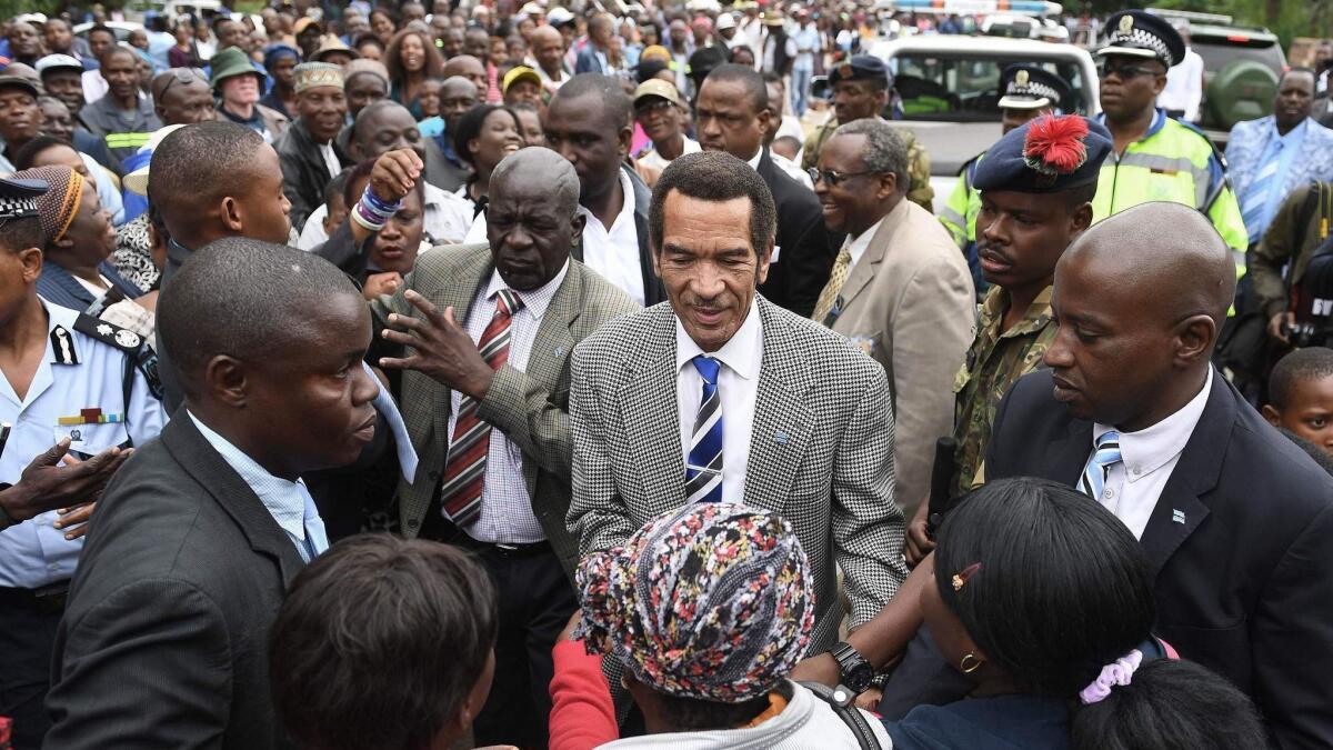 Botswana citizens throng to say goodbye to Ian Khama, in blue tie, who stepped down from the presidency on Saturday.