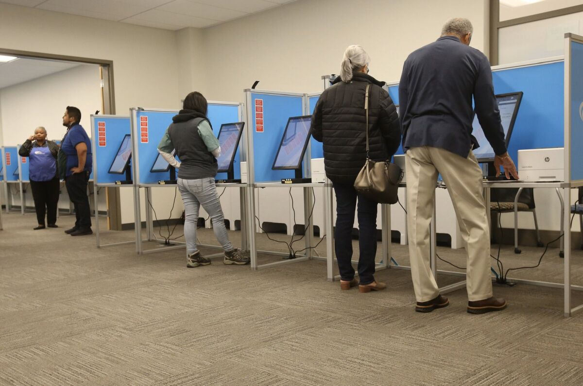 Voters cast ballots early Tuesday at the county Registar of Voters office in Kearny Mesa on Super Tuesday.