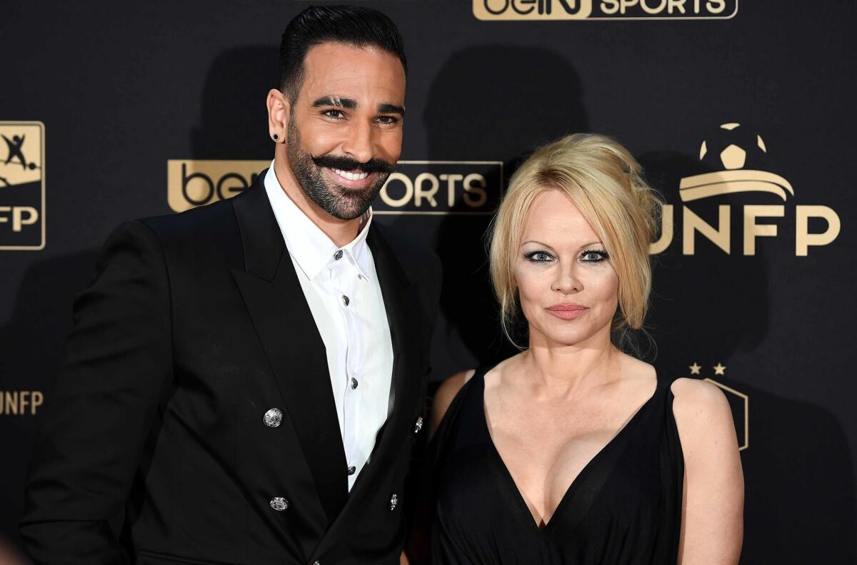 Marseille's defender Adil Rami (L) and US actress Pamela Anderson arrive to take part in a TV show on May 19, 2019 in Paris.