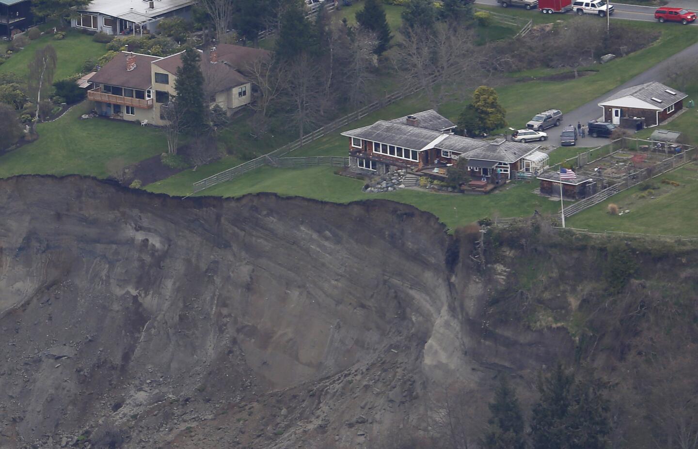 In this aerial photo, a house is seen sitting near the edge of the landslide area on Whidbey Island.