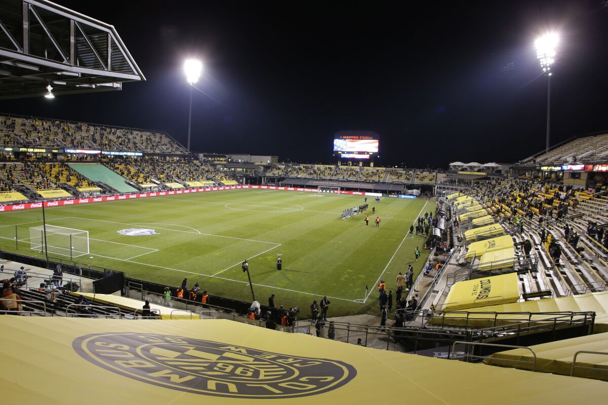 Seattle Sounders and Columbus Crew players line up for the national anthem before the MLS Cup championship match.
