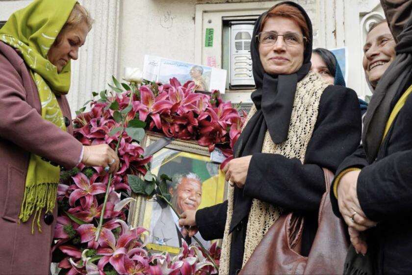 Iranian human rights lawyer and activist Nasrin Sotoudeh with portrait of Nelson Mandela in a wreath in the documentary "Nasrin."