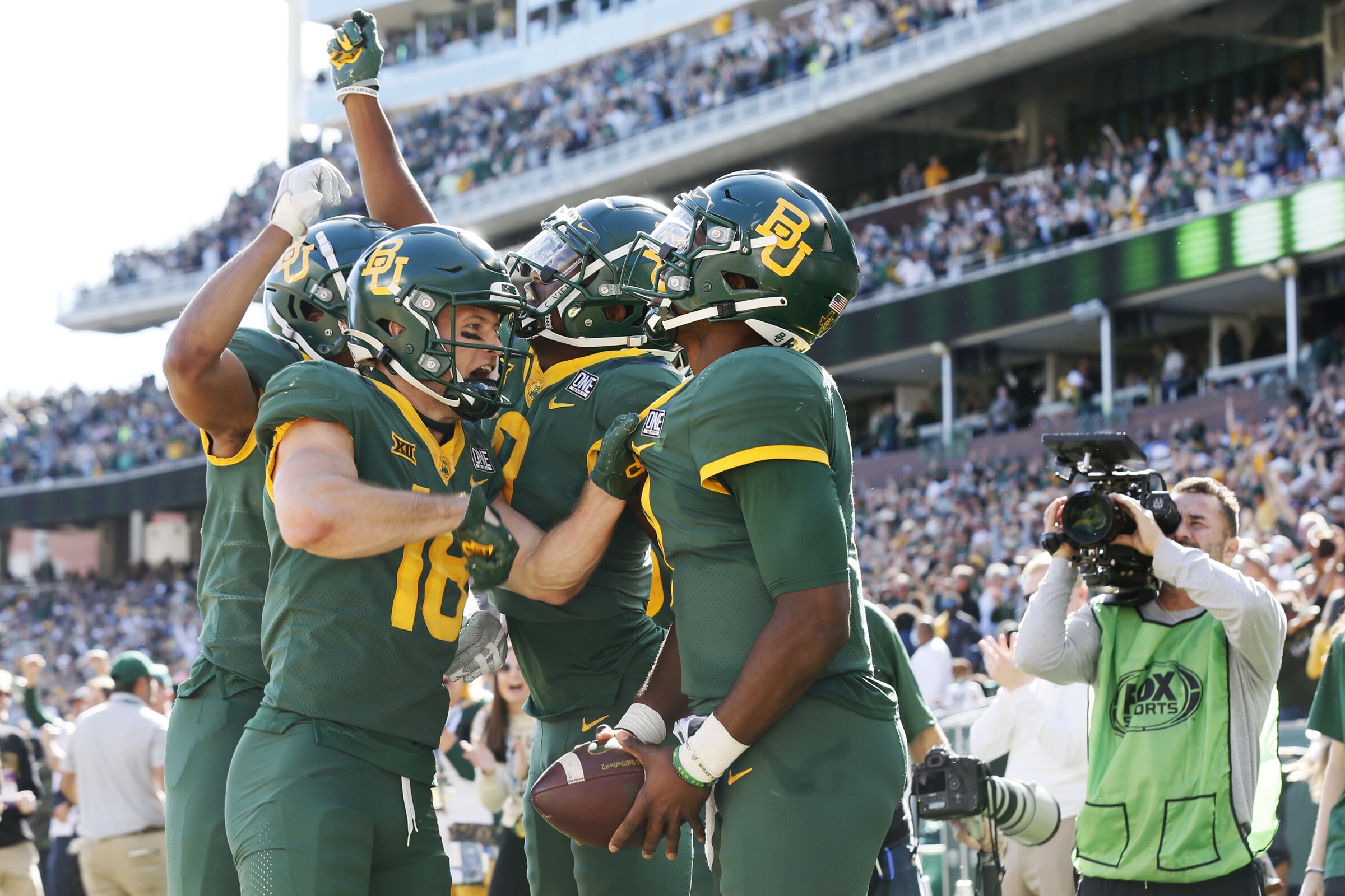 Baylor quarterback Gerry Bohanon, right, rejoices with teammates after scoring on a 14-yard touchdown run Nov. 13, 2021.