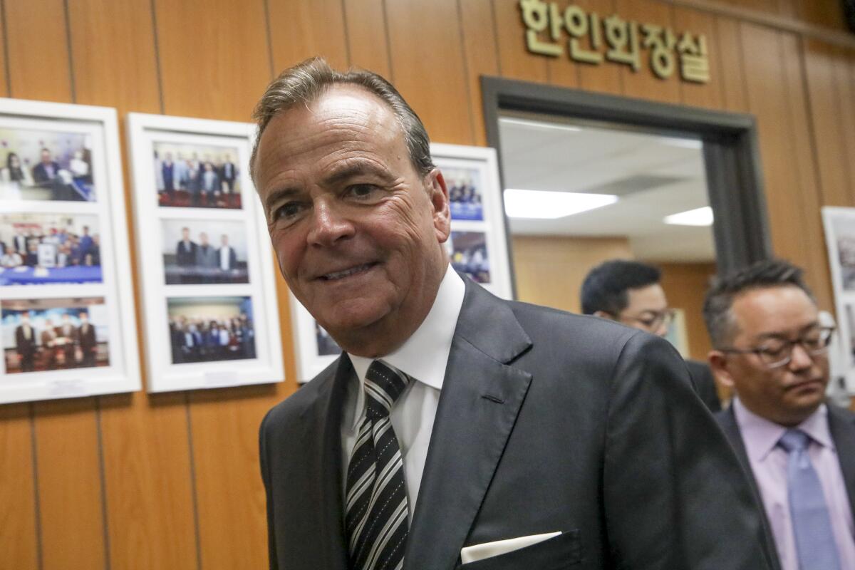 Rick Caruso in a room with Korean-language signs
