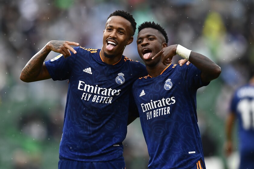 Real Madrid's Vinicius Junior, right, celebrates with Eder Militao after scoring his side's second goal during a Spanish La Liga soccer match between Elche and Real Madrid at the Martinez Valero stadium in Elche, Spain, Saturday, Oct. 30, 2021. (AP Photo/Jose Breton)