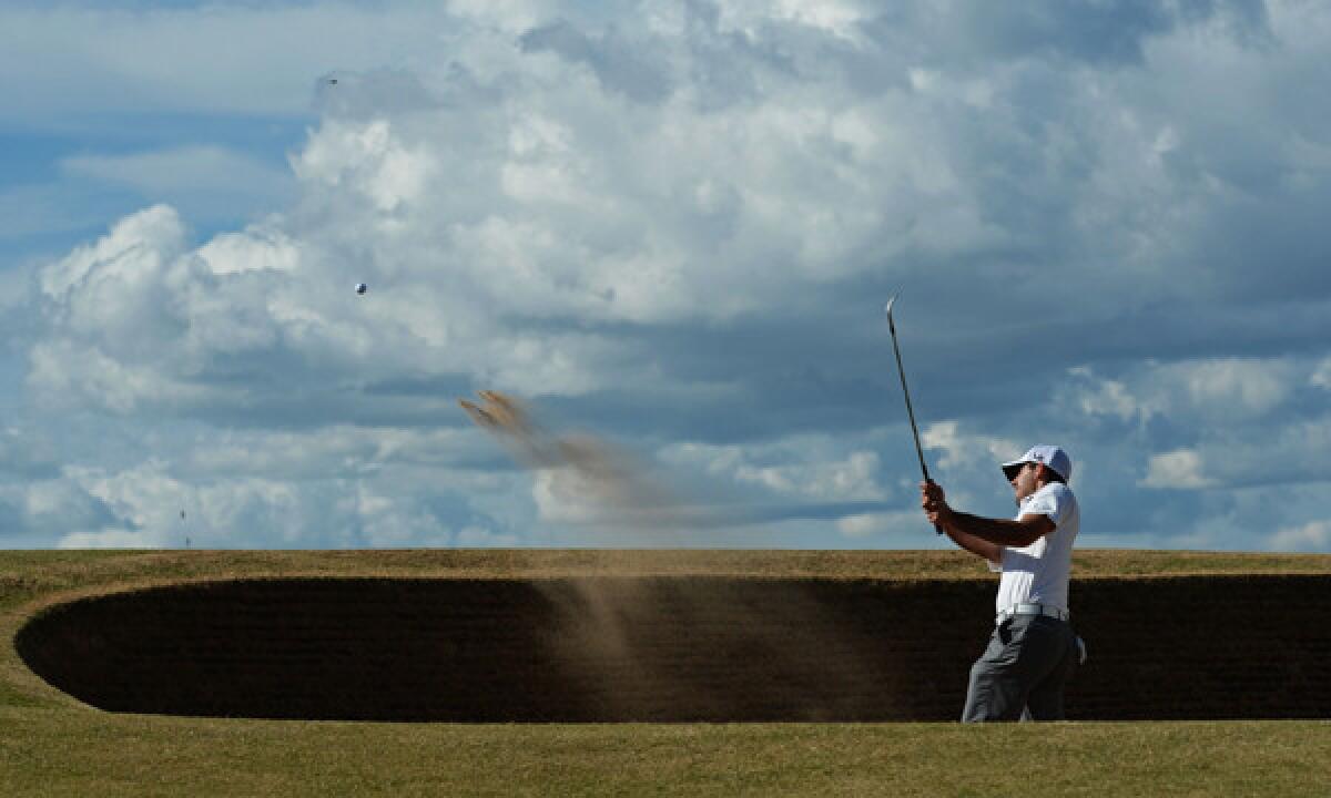 Charl Schwartzel hits out of a bunker on the 12th hole during the first round of the 2013 British Open at Muirfield in Scotland. Muirfield has been asked to consider allowing women to become members.