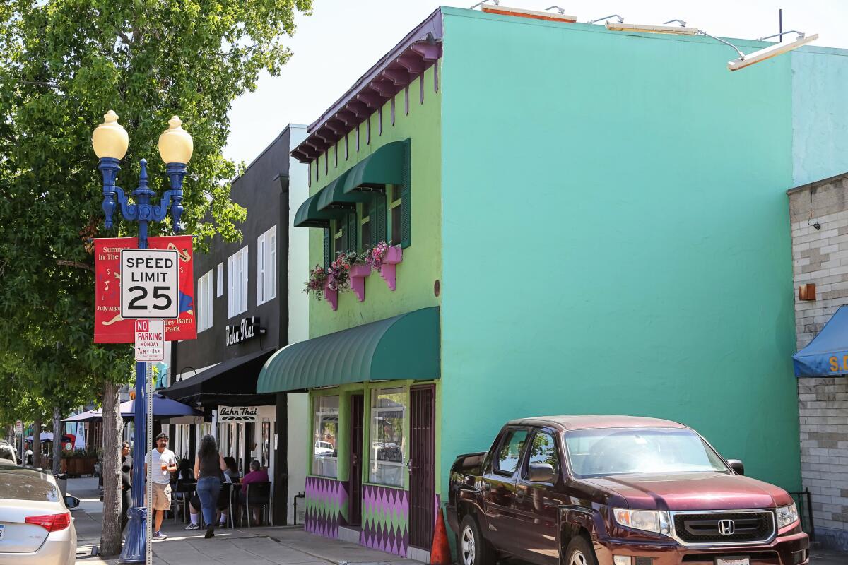 Sandwiched between a Thai food restaurant, left, and an auto mechanic shop is the green, two-story building that is the Haven family's compound.