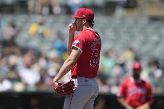 Los Angeles Angels pitcher Jack Kochanowicz reacts after walking Oakland Athletics' Max Schuemann.