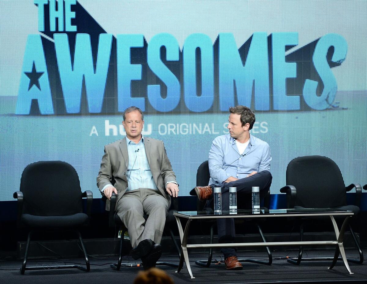 BEVERLY HILLS, CA - JULY 31: Co-Creator/Executive Producer/Writer Michael Shoemaker (L) and Co-Creator/Writer/Actor Seth Meyers speak onstage during the 'The Awesomes' portion of the Hulu 2013 Summer TCA Tour at The Beverly Hilton Hotel on July 31, 2013 in Beverly Hills, California.