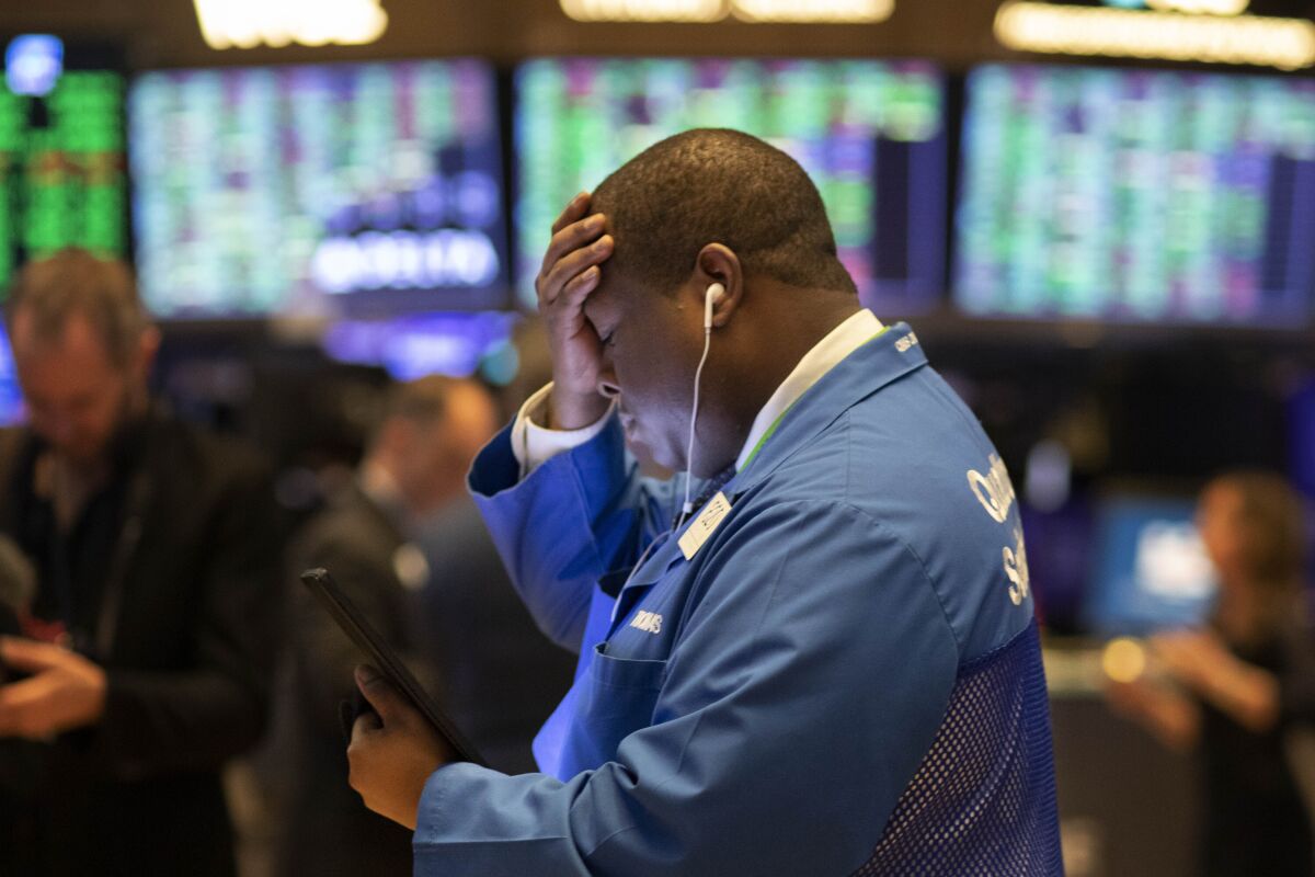 Stock trader Thomas Lee works at the New York Stock Exchange, Friday, March 13, 2020. Stocks are opening sharply higher on Wall Street a day after the worst drop since 1987. (AP Photo/Mark Lennihan)