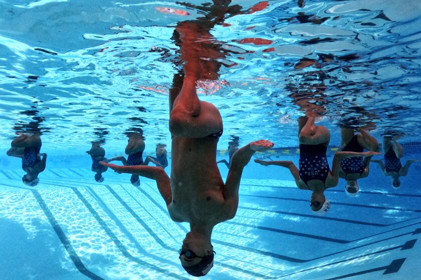 The USA Artistic Swimming team including Kenny Gaudet, center, practice at UCLA