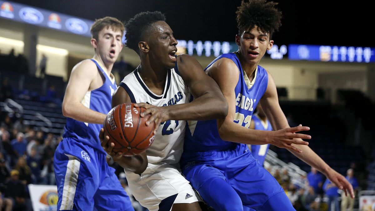 Chino Hills' Onyeka Okongwu is guarded by Santa Margarita's Jake Kyman (13), left, and Max Agbonkpolo in the CIF-SS Division 1 championship game Feb. 23 at Cal Baptist.