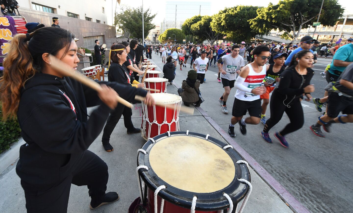 Drummers pound a beat for runners in downtown during the L.A. Marathon.
