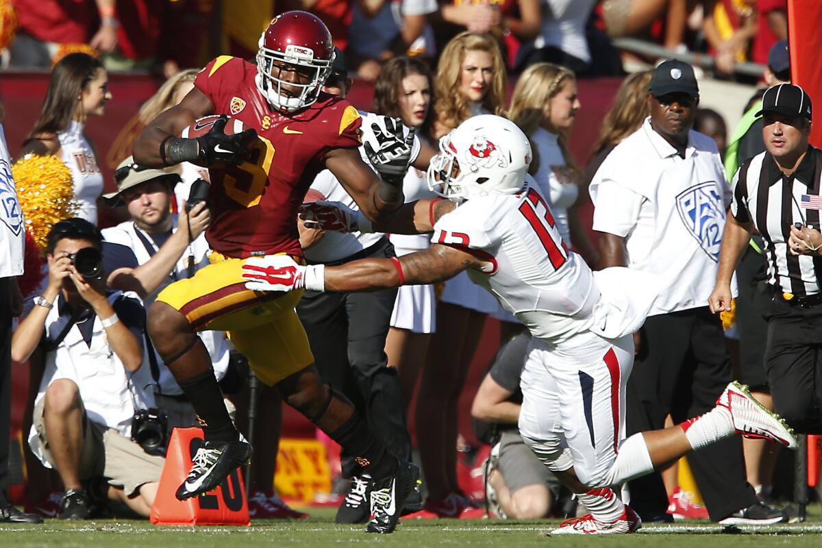 USC receiver JuJu Smith tries to get past Fresno State safety Derron Smith during the Trojans' 52-13 victory at the Coliseum on Aug. 30.