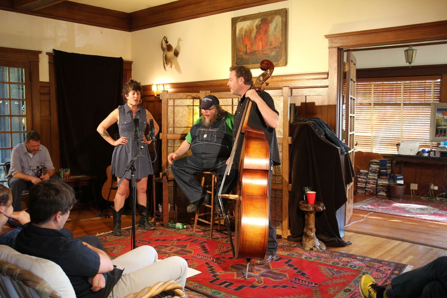 The show in early May brought together musicians from around the country. Performers from left: Sabra Guzman, Riley Baugus and Travis Stuart. Stuart often plays with his brother Trevor, who can be seen seated at far left.