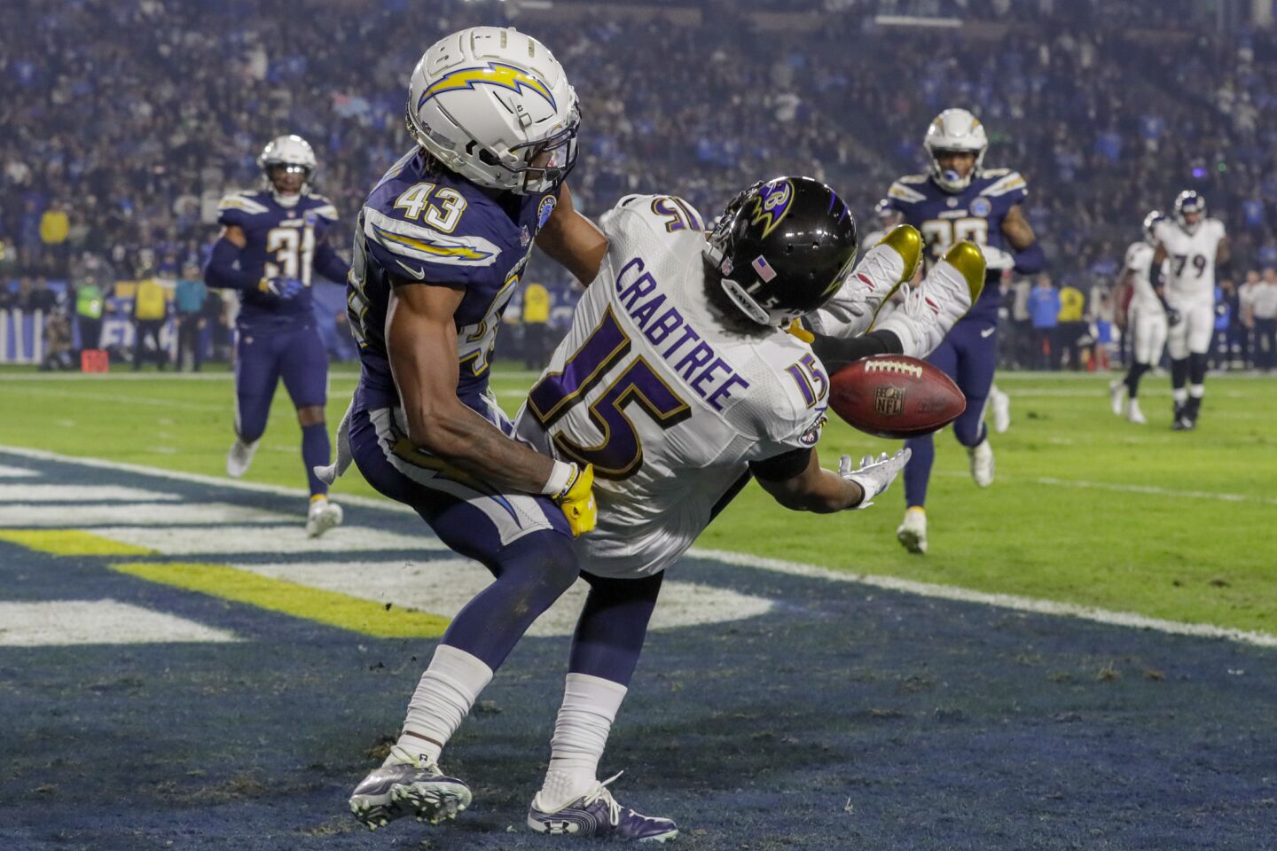 Chargers cornerback Michael Davis knocks the ball from Ravens receiver Michael Crabtree, preventing a first half touchdown at StubHub Center.