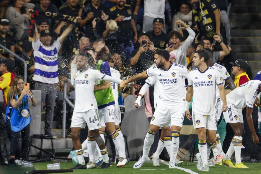 LA Galaxy players celebrate their goal against the Los Angeles FC during the second half of an MLS playoff soccer match on Thursday, Oct. 20, 2022, in Los Angeles. Los Angeles FC won 3-2. (AP Photo/Ringo H.W. Chiu)