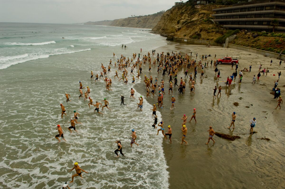 Swimmers take to the water for the Pier to Cove Swim in 2013. This year's version will be held Sunday, June 26.